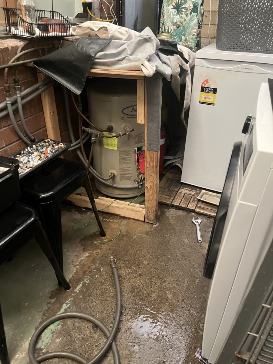 Compact Aquamax electric storage hot water system installed in a Sydney laundry