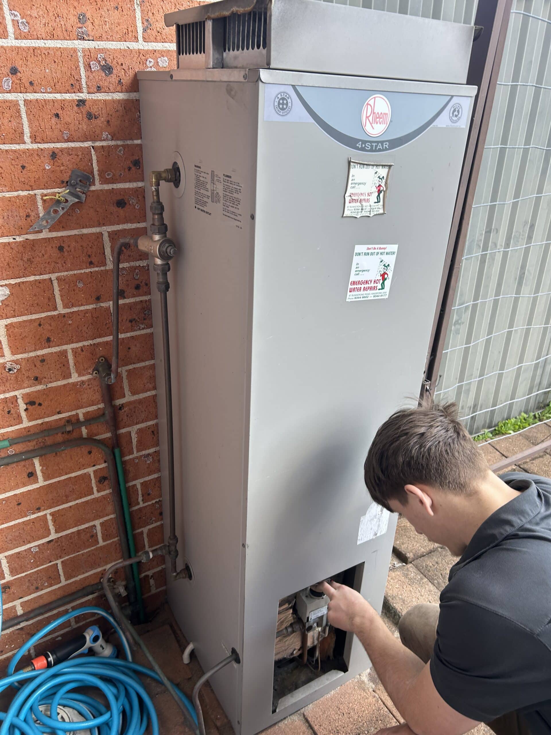 Emergency Hot Water Repairs plumber repairing a hot water system in Sydney