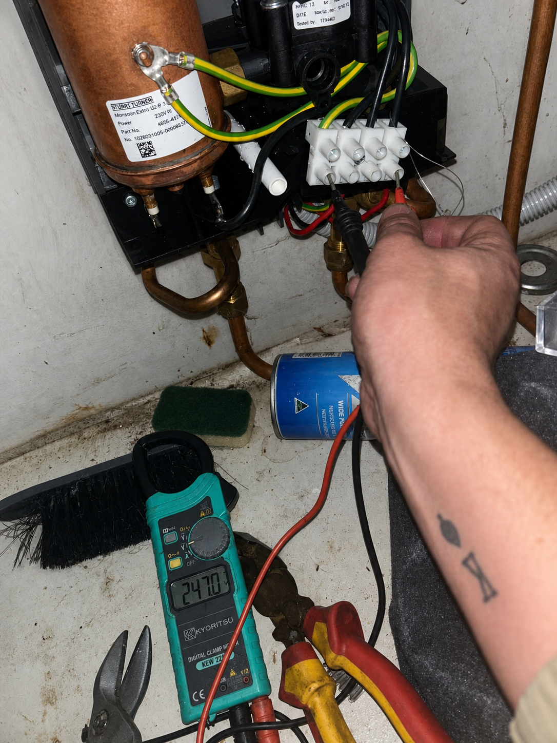 Electric hot water system fault testing with a multimeter during a repair in Rosebery, Sydney