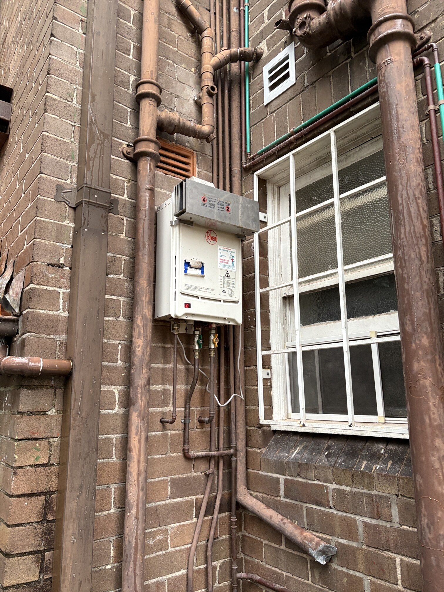 Emergency Hot Water Repairs technician with a new hot water system in Canterbury