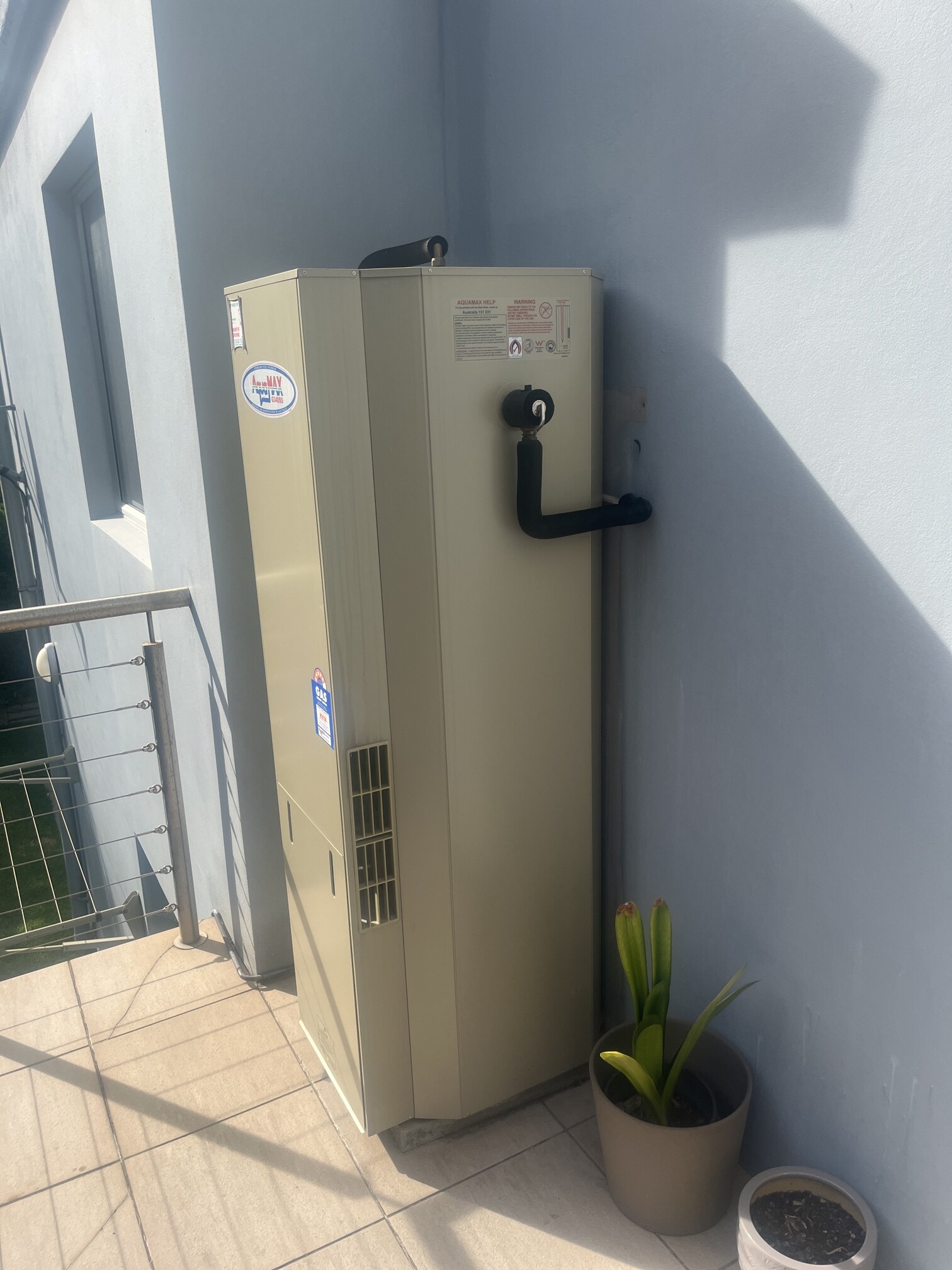 Emergency Hot Water Repairs technician with a new hot water system in Bondi Beach