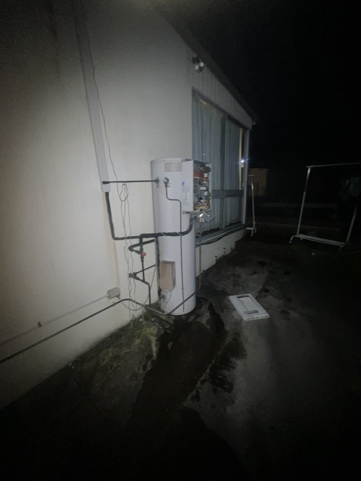 Emergency Hot Water Repairs technician with a new hot water system in Tempe